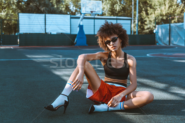 Sportos nő fiatal viselet magassarkú ül Stock fotó © LightFieldStudios