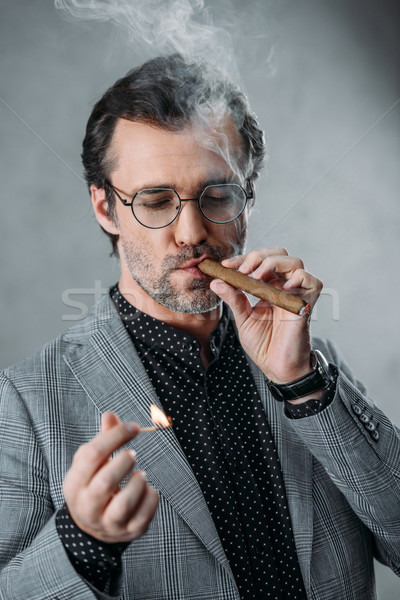 businessman smoking cigar Stock photo © LightFieldStudios
