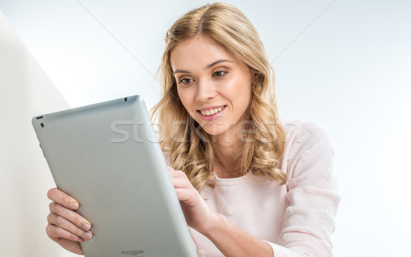 Woman using digital tablet Stock photo © LightFieldStudios