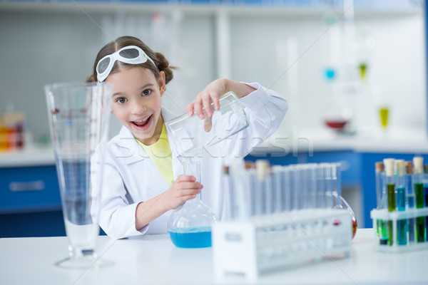 Excited little girl scientist making experiment in laboratory Stock photo © LightFieldStudios