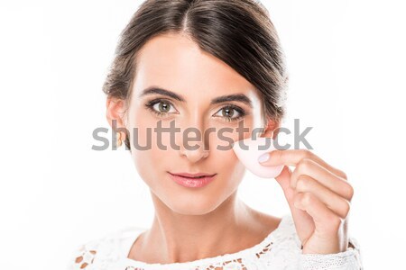 woman with makeup sponge in hand Stock photo © LightFieldStudios