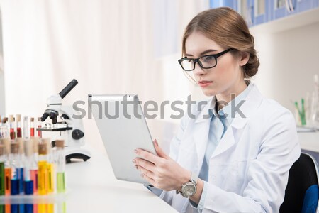 Tudós digitális tabletta fiatal női szemüveg Stock fotó © LightFieldStudios