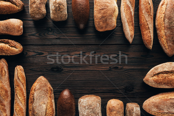top view of arranged loafs of bread on wooden surface Stock photo © LightFieldStudios