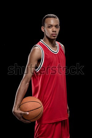 Young confident basketball player standing with ball and looking at camera Stock photo © LightFieldStudios