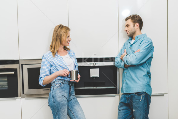 Vue de côté couple conversation cuisine maison vêtements [[stock_photo]] © LightFieldStudios