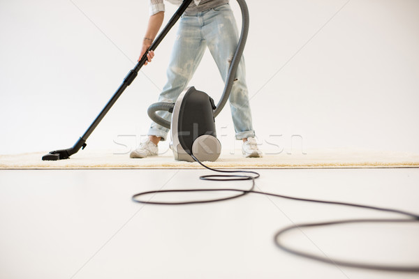 Woman vacuuming carpet Stock photo © LightFieldStudios
