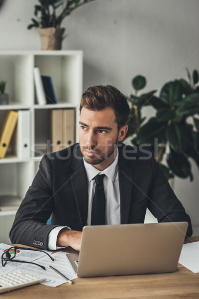 thoughtful businessman with laptop Stock photo © LightFieldStudios