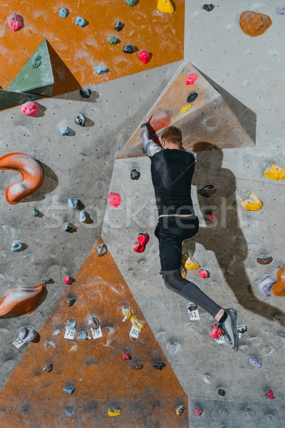 Man climbing wall with grips Stock photo © LightFieldStudios