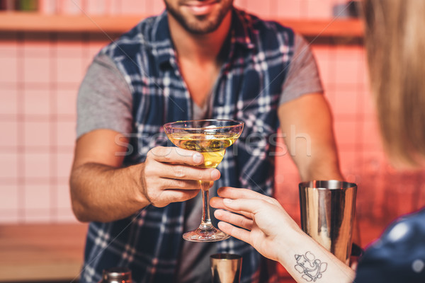 Stock photo: barman giving cocktail to visitor