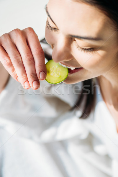 woman eating slice of cucumber Stock photo © LightFieldStudios