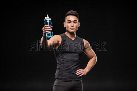 asian sportsman with sports bottle Stock photo © LightFieldStudios