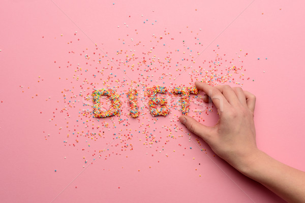 Primo piano view parola dieta dolci mano umana Foto d'archivio © LightFieldStudios