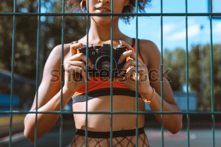 sportive woman taking picture with camera Stock photo © LightFieldStudios