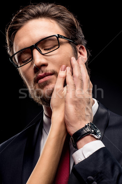 Businessman with female hand on face Stock photo © LightFieldStudios