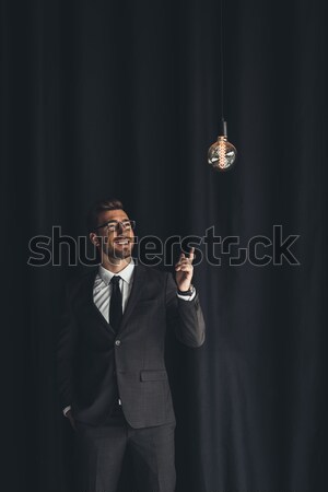 handsome businessman with lightbulb Stock photo © LightFieldStudios