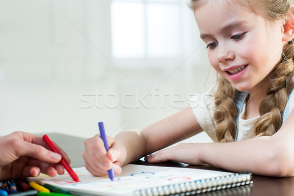 Happy mother and daughter drawing at home Stock photo © LightFieldStudios