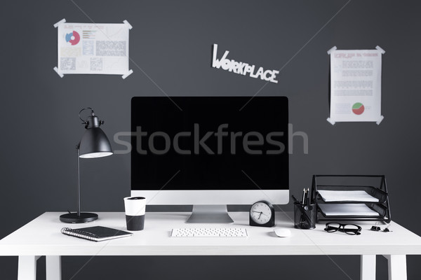 desktop computer with blank screen, business charts and office supplies at workplace Stock photo © LightFieldStudios