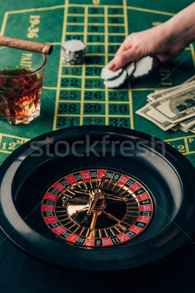 Woman placing a bet on table with roulette Stock photo © LightFieldStudios