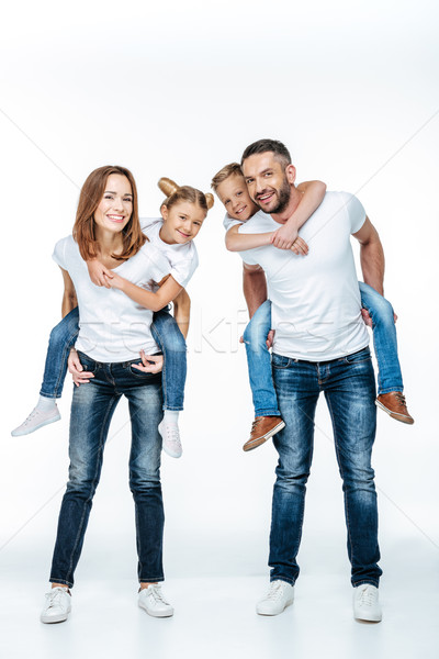 Parents piggybacking happy children Stock photo © LightFieldStudios