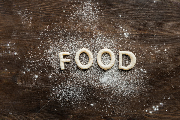 top view of cookies in forms of letters with powdered sugar, cookie dough Stock photo © LightFieldStudios