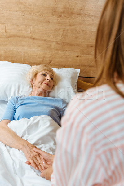 Sick senior woman in bed Stock photo © LightFieldStudios