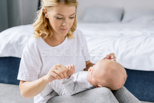 mother holding babys hands Stock photo © LightFieldStudios