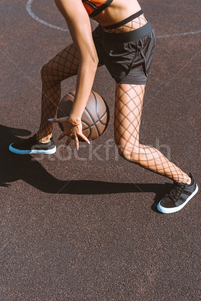 woman dribbling basketball Stock photo © LightFieldStudios