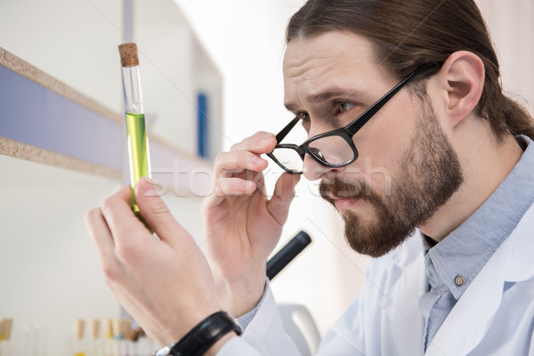 Cientista olhando test tube jovem masculino químico Foto stock © LightFieldStudios