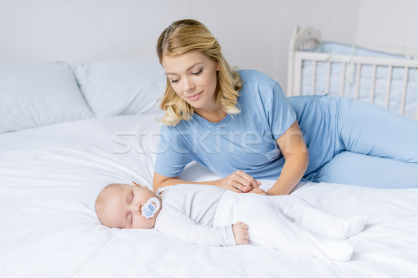 mother looking at sleeping baby Stock photo © LightFieldStudios
