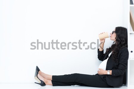 pregnant businesswoman drinking coffee Stock photo © LightFieldStudios