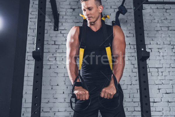man exercising with trx gym equipment Stock photo © LightFieldStudios