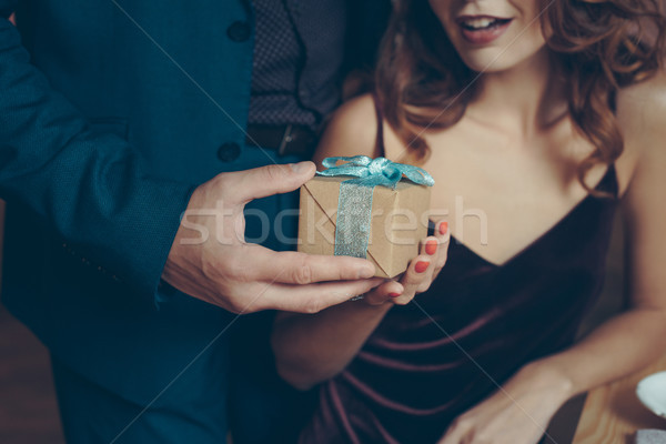 man presenting gift to girlfriend Stock photo © LightFieldStudios