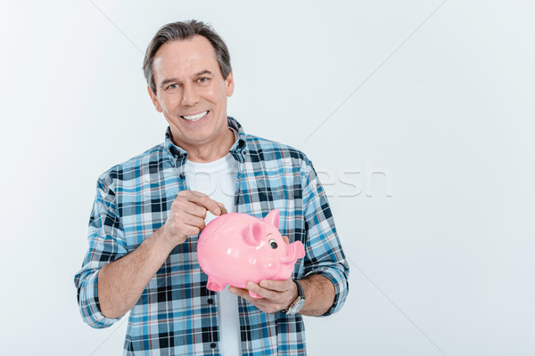 Front widoku szczęśliwy człowiek monety banku piggy Zdjęcia stock © LightFieldStudios