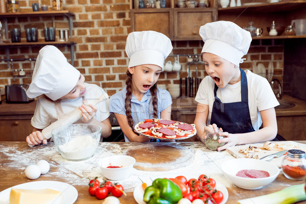 kids in chef hats making pizza together Stock photo © LightFieldStudios