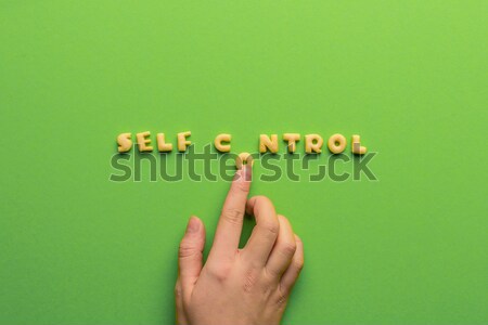 self controt concept,  person making words of cookies isolated on green. healthy lifestyle and healt Stock photo © LightFieldStudios