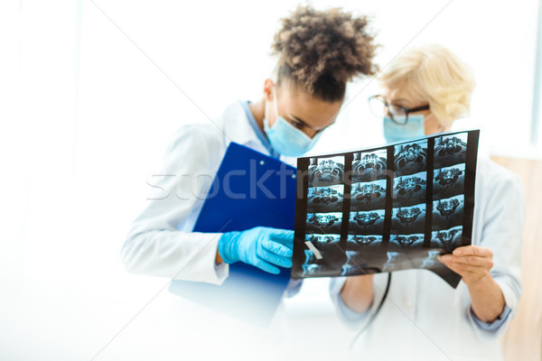 doctors examining x-ray photograph Stock photo © LightFieldStudios