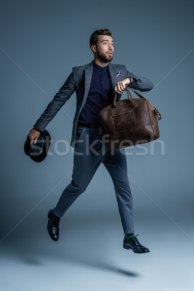 Worried man walking with leather bag Stock photo © LightFieldStudios