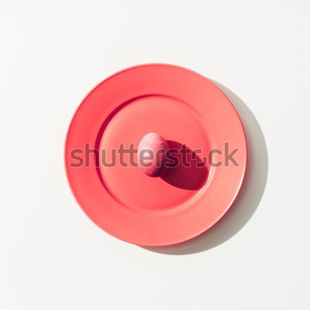 top view of shabby red easter egg on red plate, on white Stock photo © LightFieldStudios