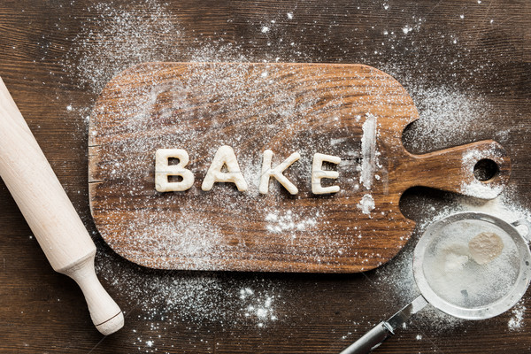 Top view of edible lettering bake made from dough on wooden cutting board, baking cookies concept Stock photo © LightFieldStudios