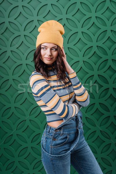 Woman posing in pullover, hat and overalls Stock photo © LightFieldStudios