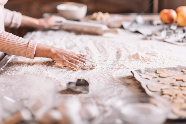 Stock photo: 'Partial view of woman kneading dough at kitchen table