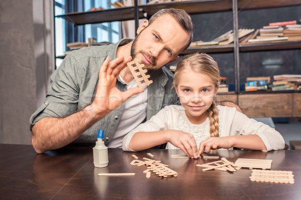 Father and daughter making figure Stock photo © LightFieldStudios