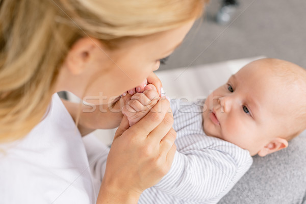 mother holding babys hands Stock photo © LightFieldStudios