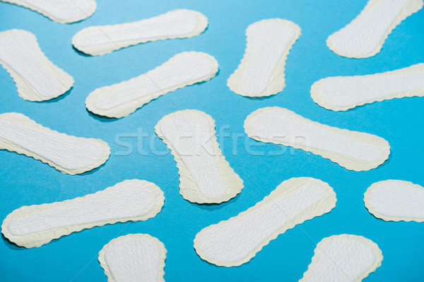 scattered protective daily pads on blue Stock photo © LightFieldStudios