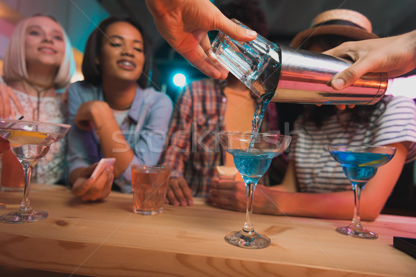 barman making cocktail for friends Stock photo © LightFieldStudios