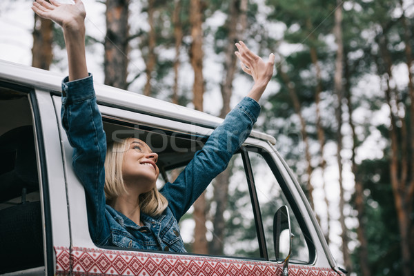 cheerful girl in retro minivan Stock photo © LightFieldStudios
