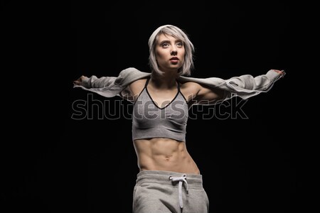 portrait of woman in sports clothing on black Stock photo © LightFieldStudios