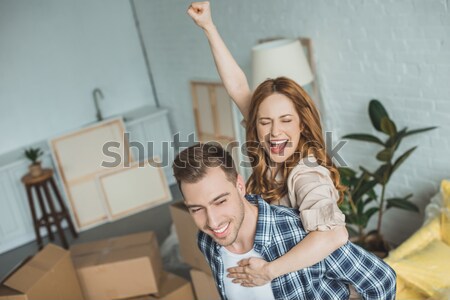 girl sitting in box and waving at camera Stock photo © LightFieldStudios