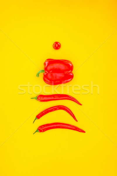 top view of fresh raw peppers and cherry tomato isolated on yellow Stock photo © LightFieldStudios