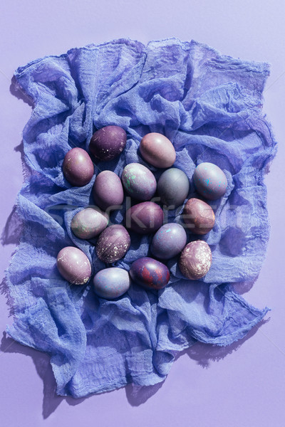 top view of traditional purple easter eggs in straw nest Stock Photo by  LightFieldStudios